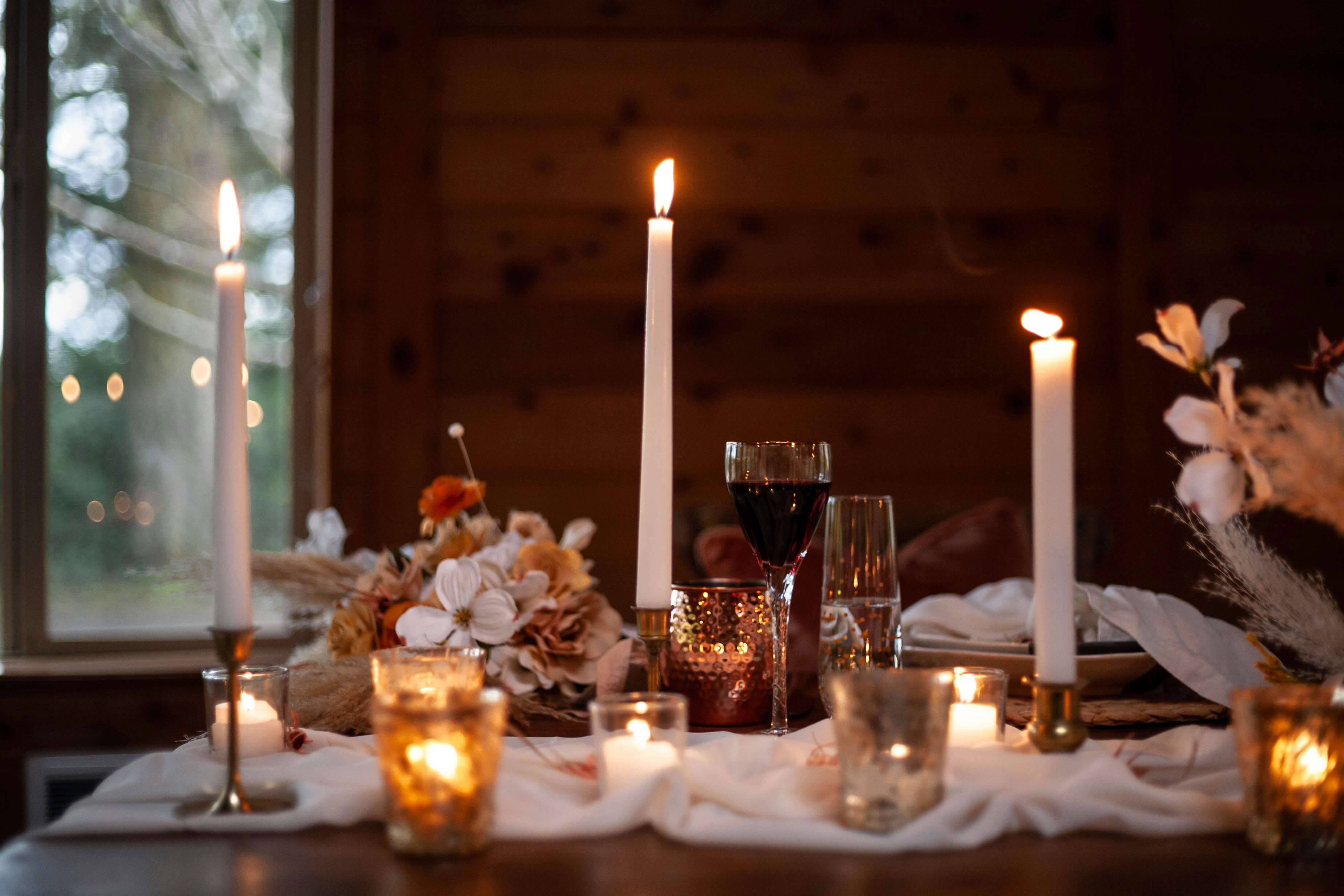 Night tablescape with candles, lavender napkins, and gold chargers